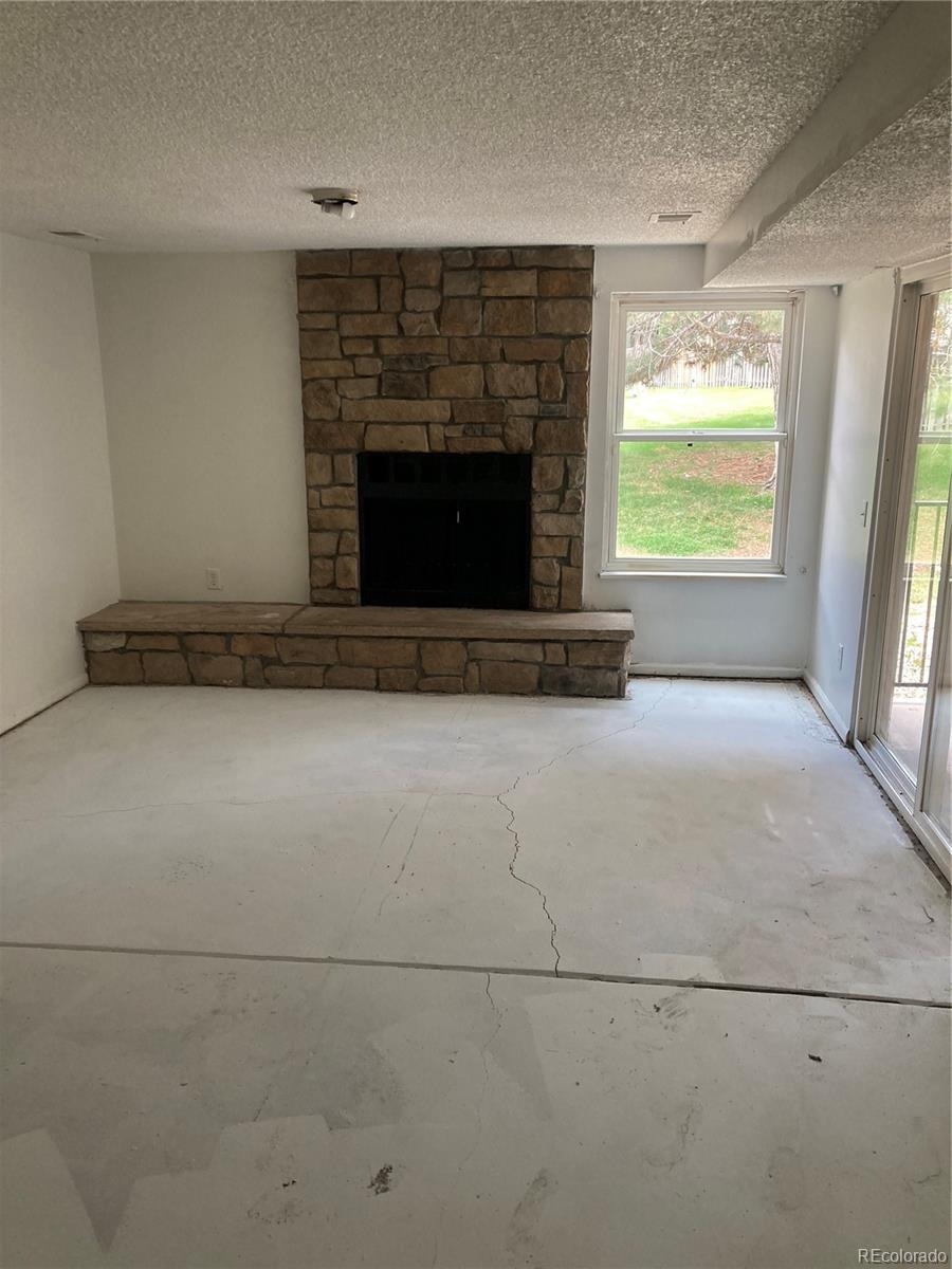 482 South Kalispell Way, Unit E Aurora, CO 80017 - Photo 11 of 12 a view of empty room with fireplace