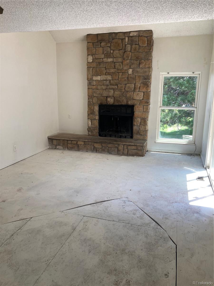 482 South Kalispell Way, Unit E Aurora, CO 80017 - Photo 3 of 12 a view of empty room with fireplace
