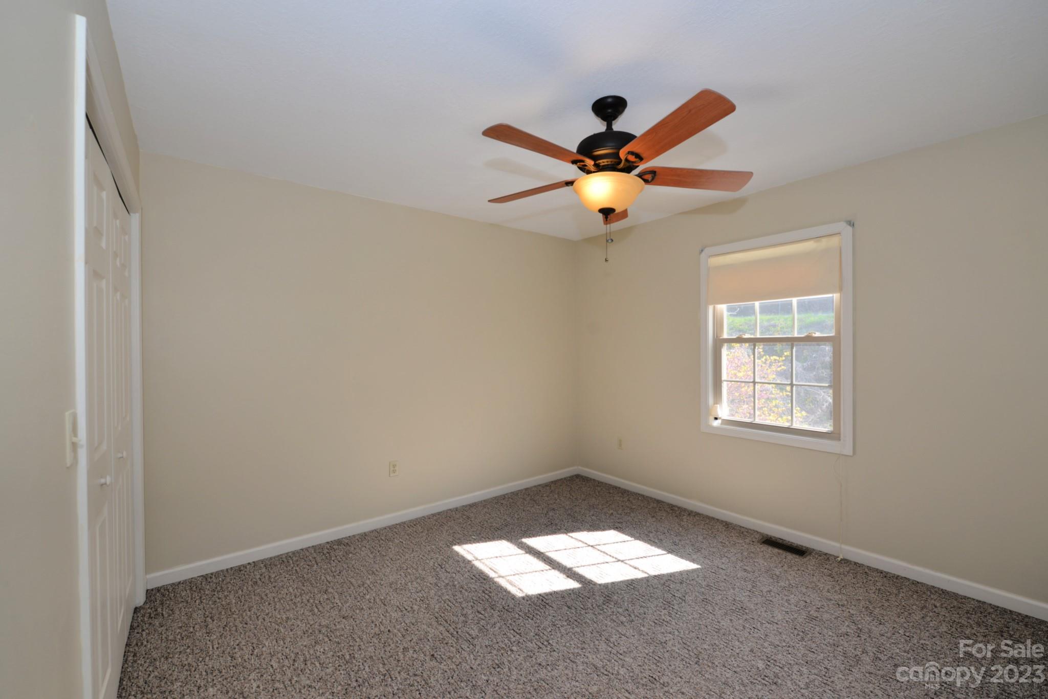 99 Bayside Drive Sylva, NC 28779 - Photo 19 of 34 an empty room with a window and a fan