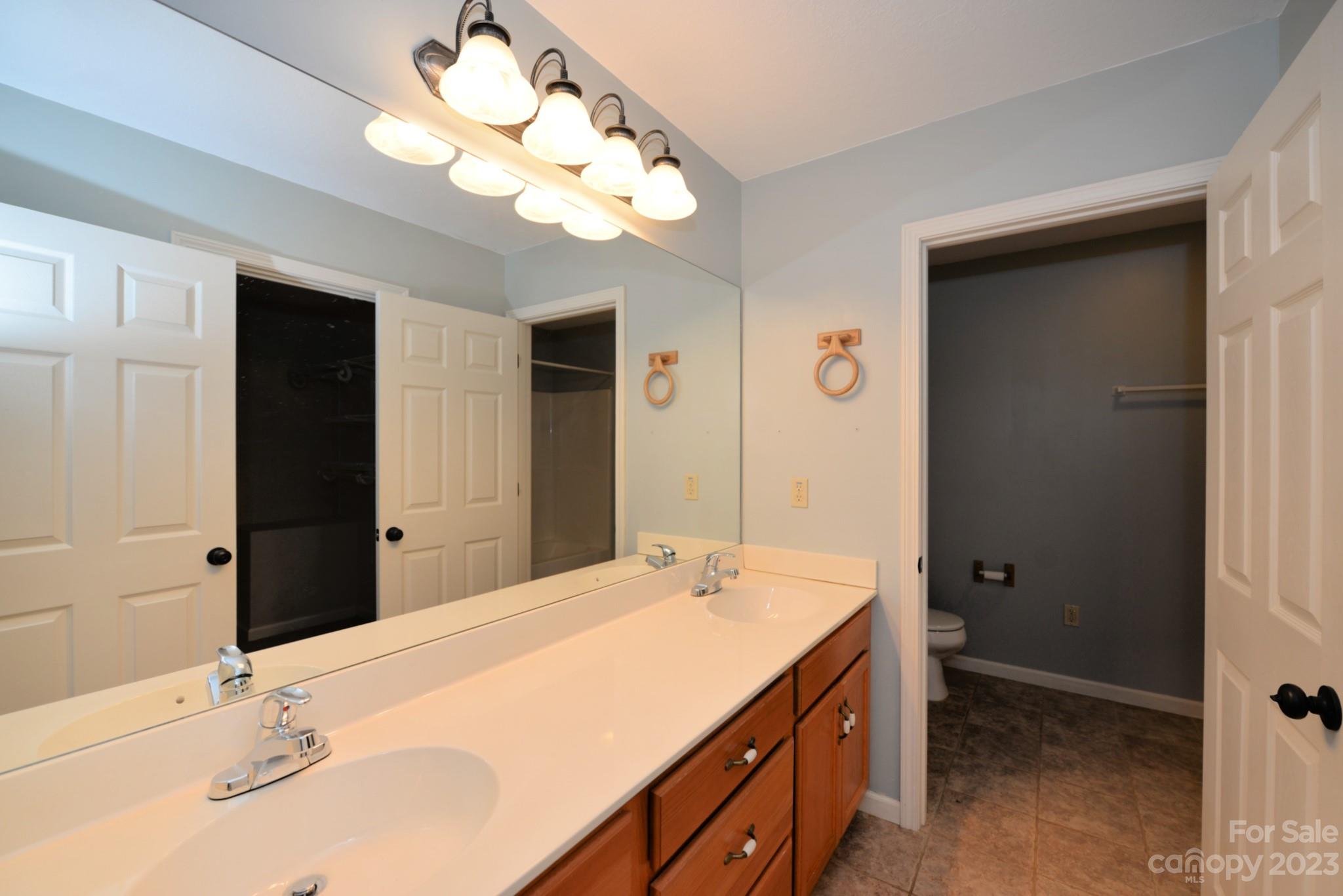 99 Bayside Drive Sylva, NC 28779 - Photo 24 of 34 a bathroom with a sink a light fixture and a mirror