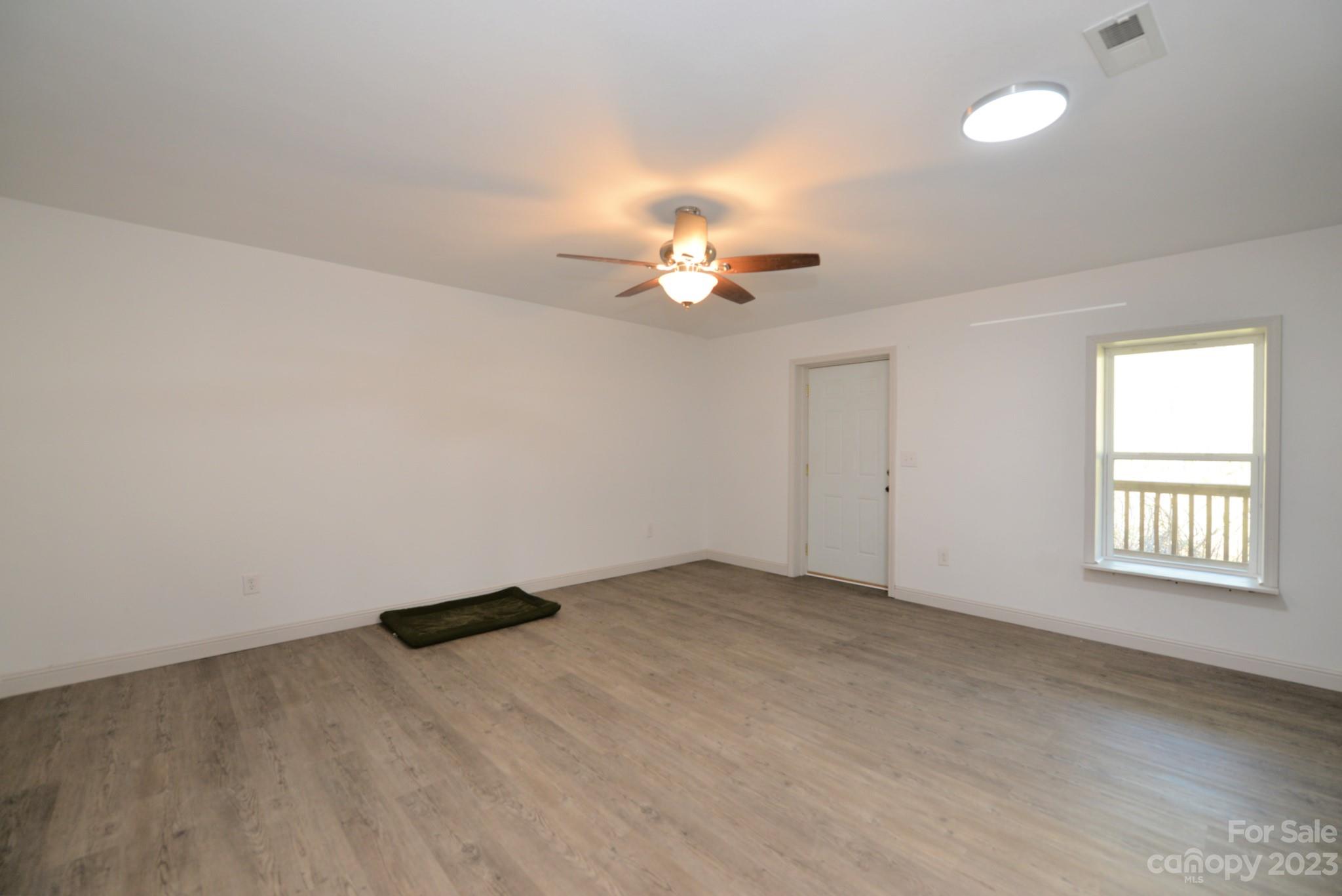 99 Bayside Drive Sylva, NC 28779 - Photo 29 of 34 wooden floor in an empty room with a window