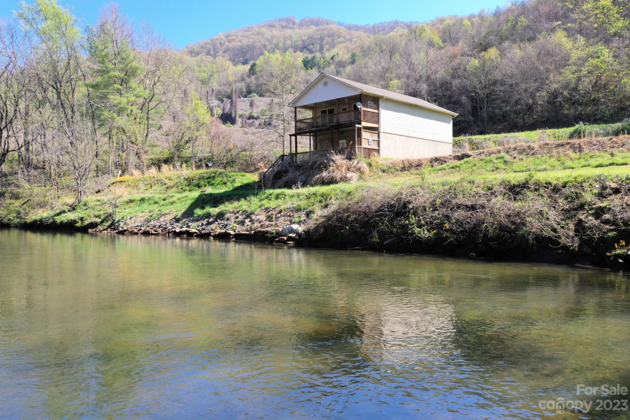 99 Bayside Drive Sylva, NC 28779 - Photo 3 of 34 a view of a lake with a mountain in the background