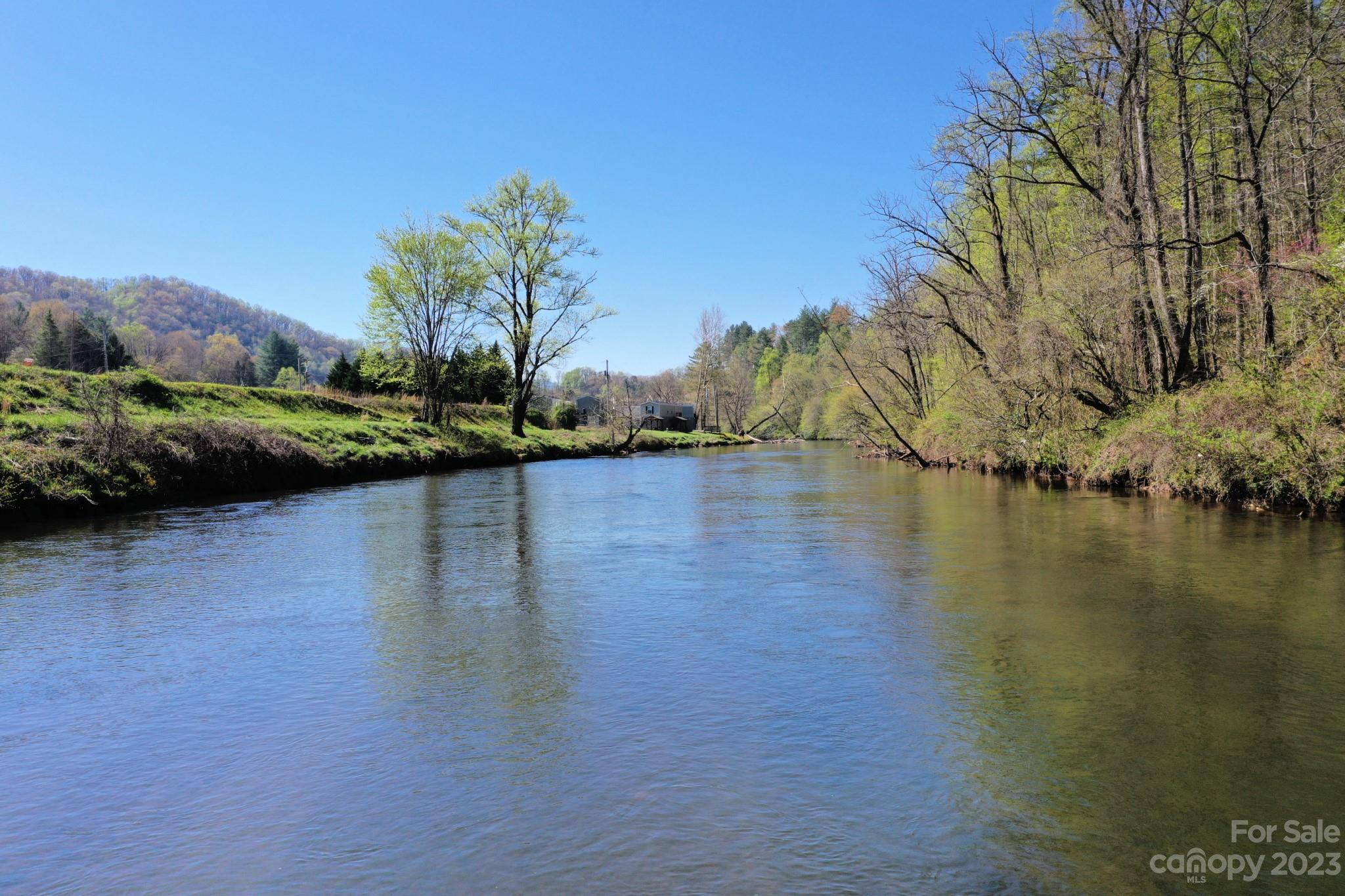 99 Bayside Drive Sylva, NC 28779 - Photo 7 of 34 a view of a lake with a yard