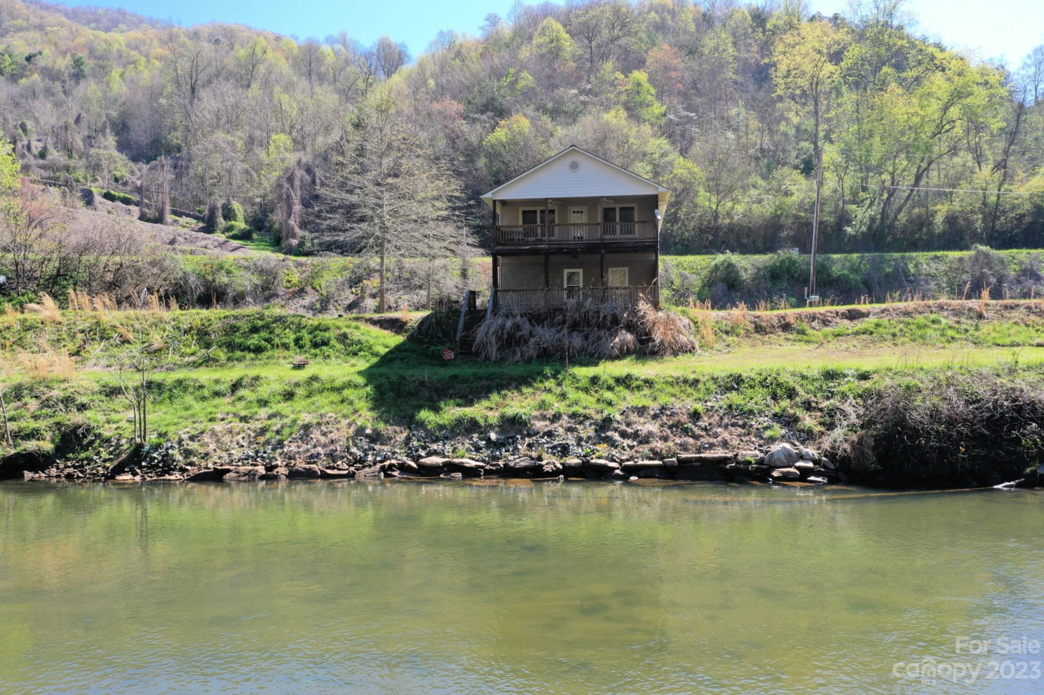 99 Bayside Drive Sylva, NC 28779 - Photo 8 of 34 a front view of a house with a yard with swimming pool