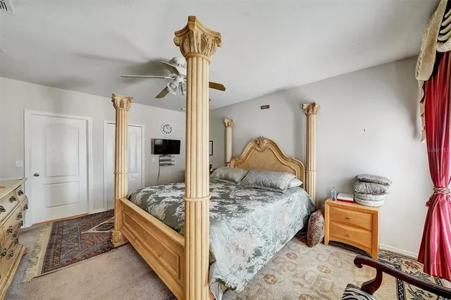 a bedroom with a bed and a view of living room