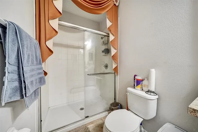 a living room with fireplace furniture and a large window
