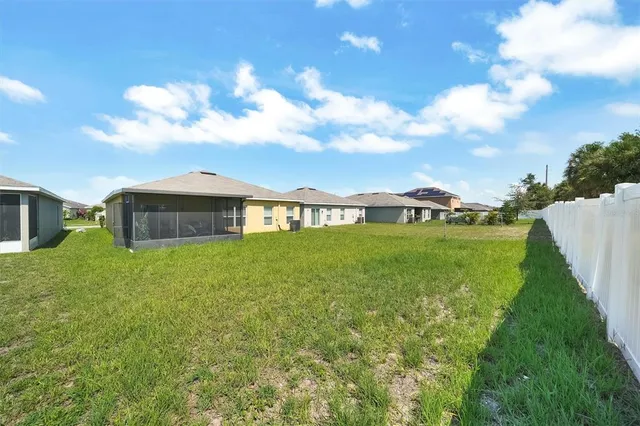 a view of an house with backyard space and balcony