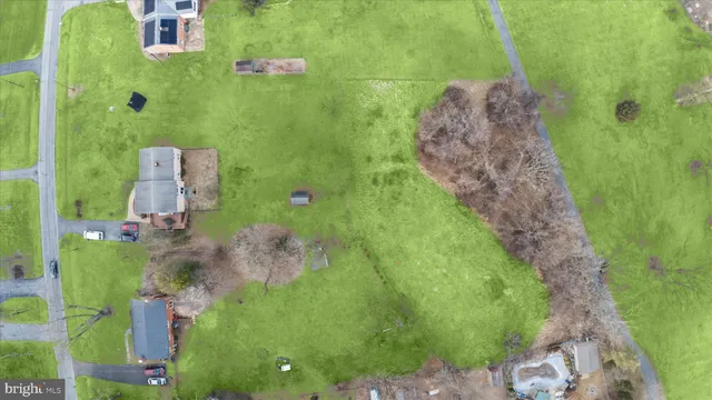 an aerial view of a golf course with parking space
