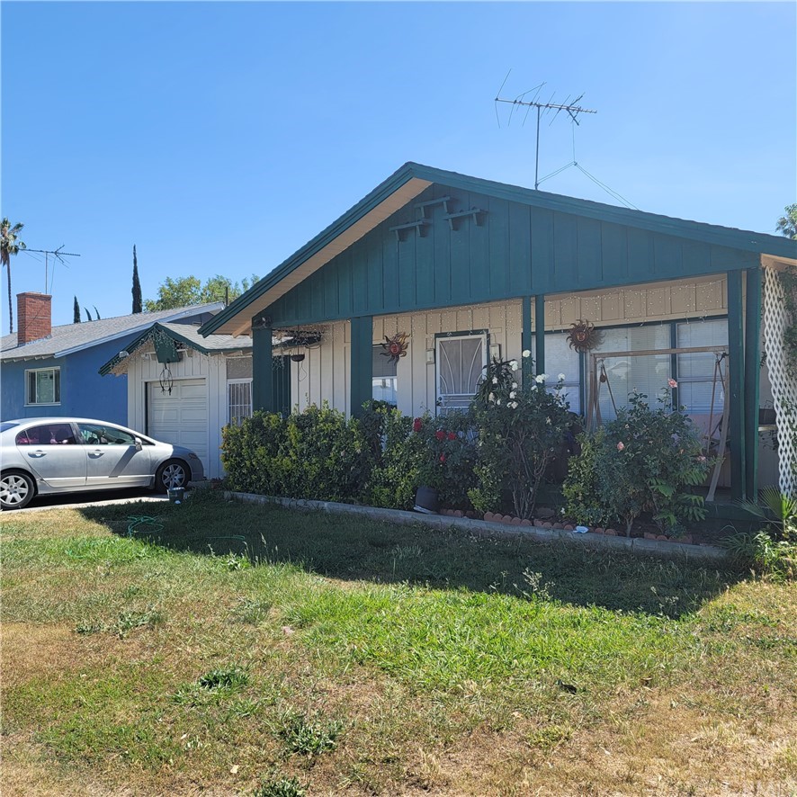 4148 St George Place Riverside, CA 92504 - Photo 1 of 1 a front view of a house with garden