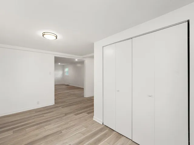 a view of hallway with wooden floor