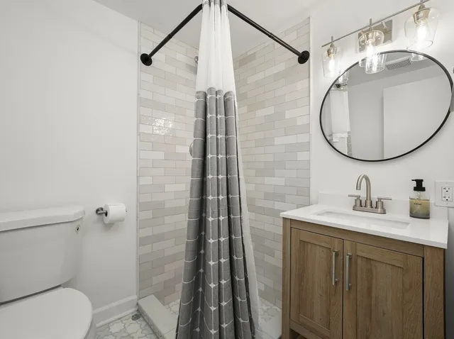 a bathroom with a sink toilet and shower