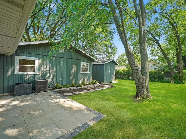 a backyard of a house with outdoor seating
