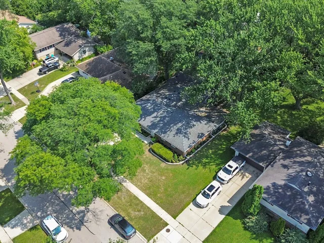 an aerial view of a residential houses with outdoor space