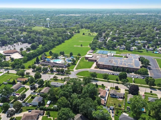 an aerial view of residential houses with outdoor space and street view