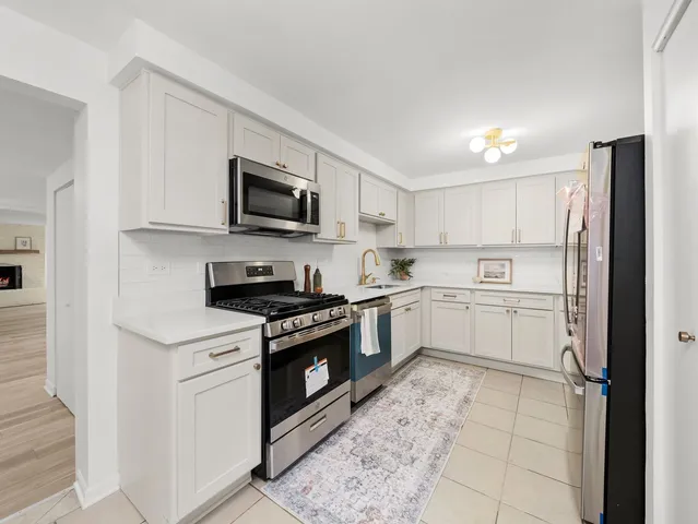 a kitchen with a stove a sink and a microwave