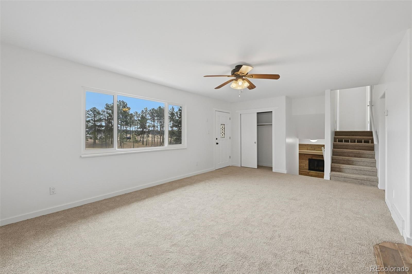7020 Wildridge Road Colorado Springs, CO 80908 - Photo 18 of 45 a view of a livingroom with a ceiling fan and window