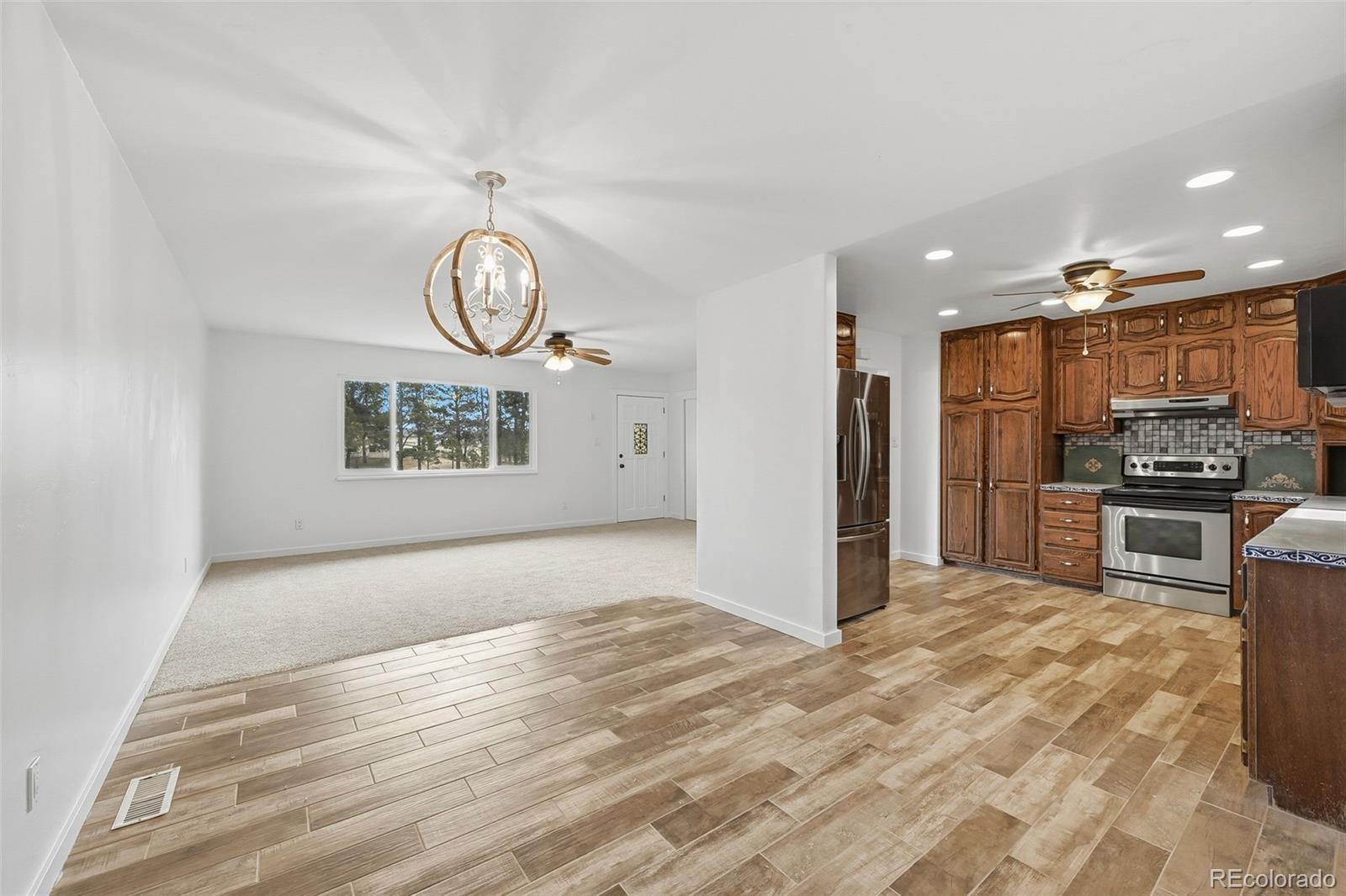 7020 Wildridge Road Colorado Springs, CO 80908 - Photo 19 of 45 a view of a kitchen with a sink and a refrigerator