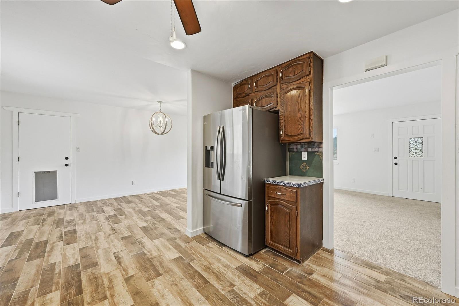 7020 Wildridge Road Colorado Springs, CO 80908 - Photo 23 of 45 a kitchen with stainless steel appliances granite countertop a refrigerator and a sink