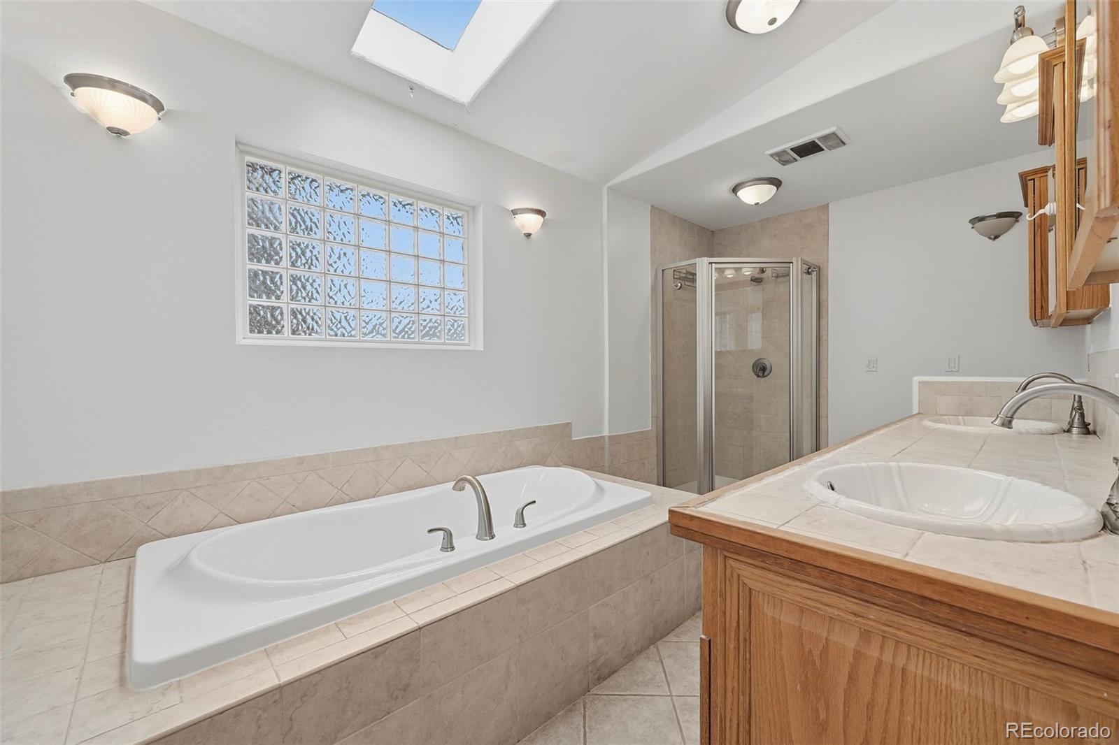7020 Wildridge Road Colorado Springs, CO 80908 - Photo 28 of 45 a bathroom with a tub sink and mirror