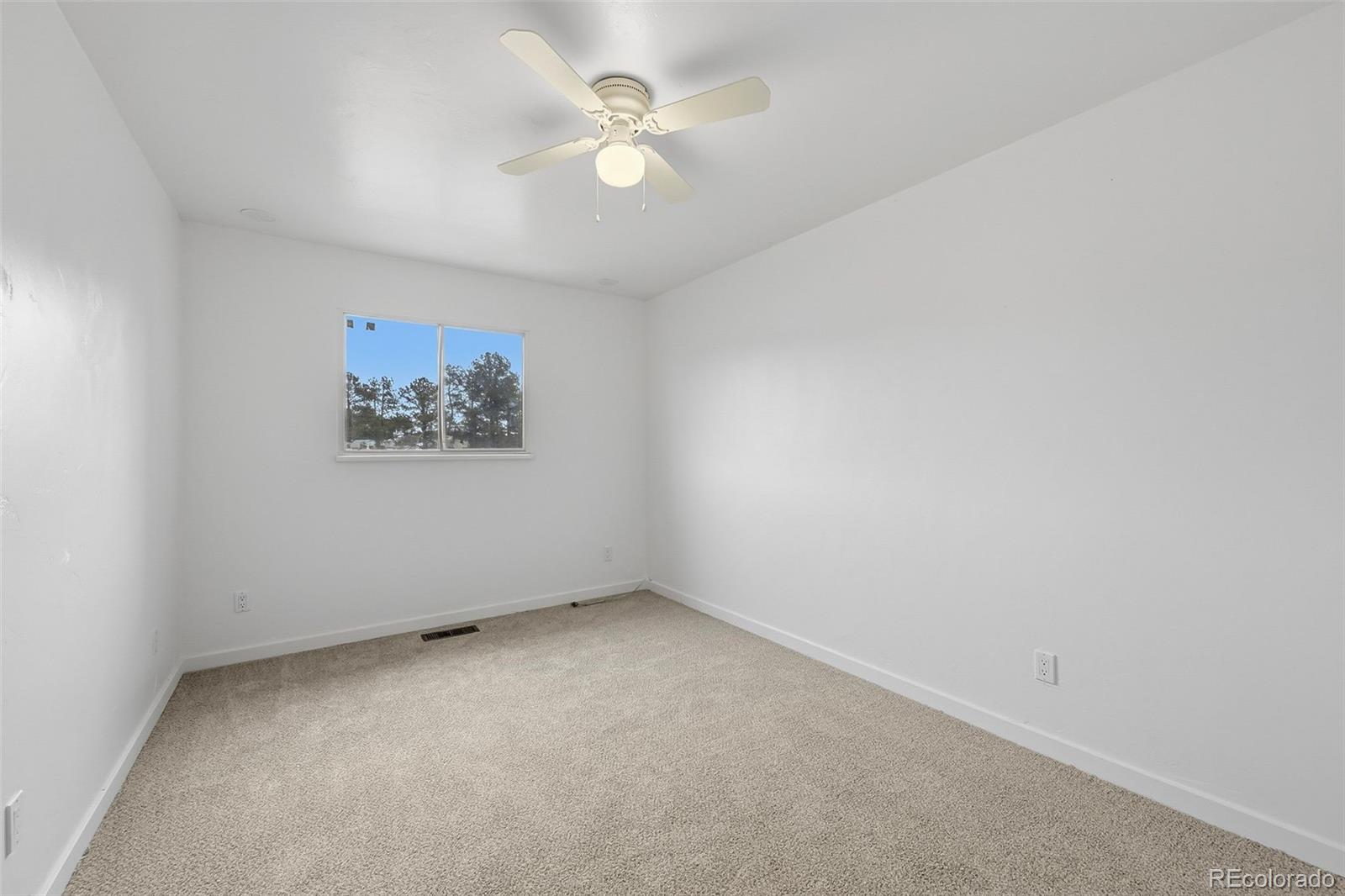 7020 Wildridge Road Colorado Springs, CO 80908 - Photo 29 of 45 an empty room with a window