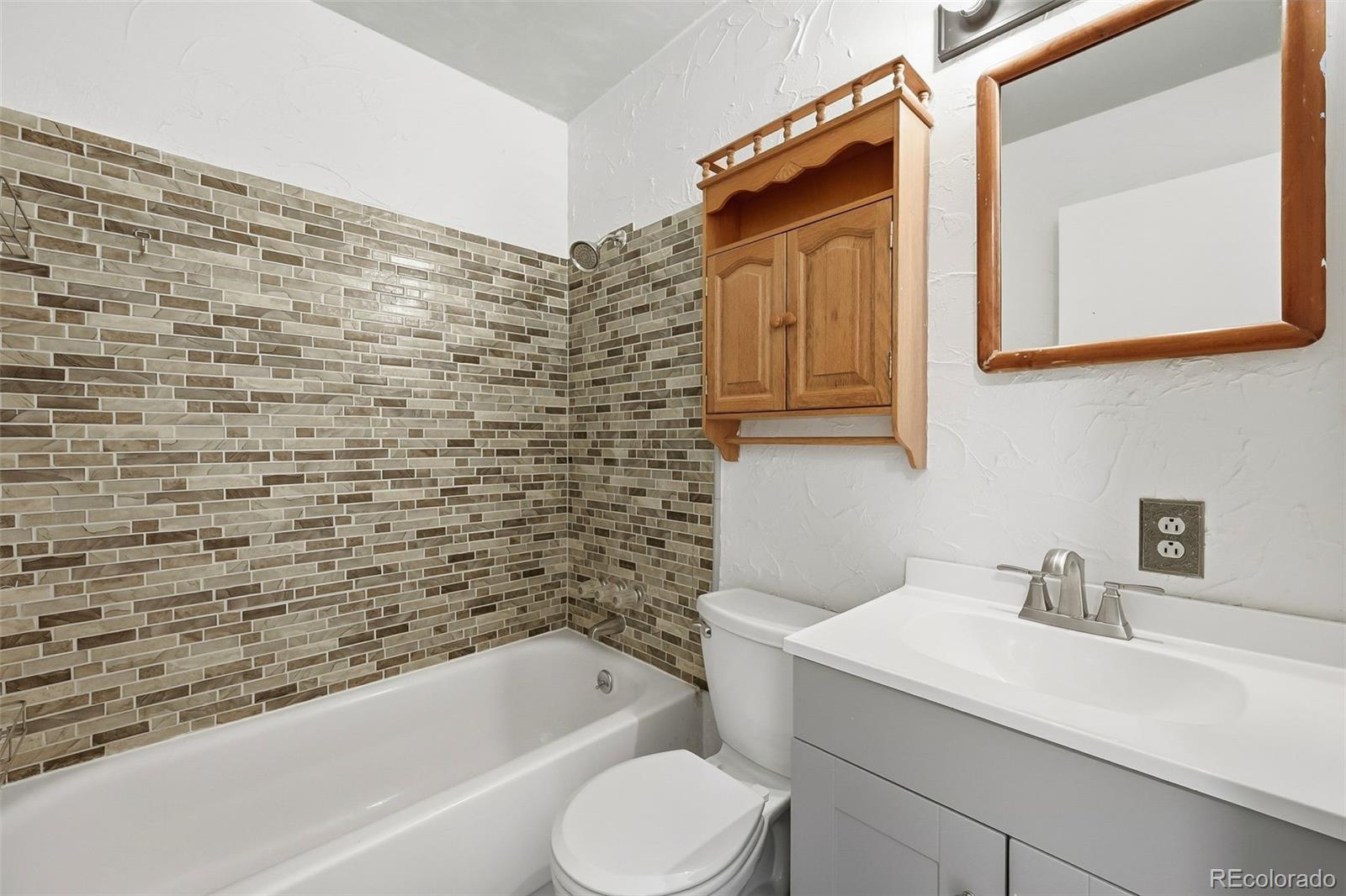 7020 Wildridge Road Colorado Springs, CO 80908 - Photo 30 of 45 a bathroom with a sink toilet and bathtub