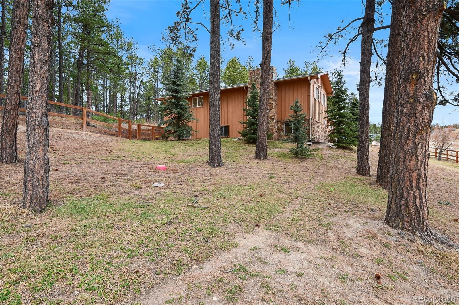 7020 Wildridge Road Colorado Springs, CO 80908 - Photo 40 of 45 a view of a house with a tree in the background