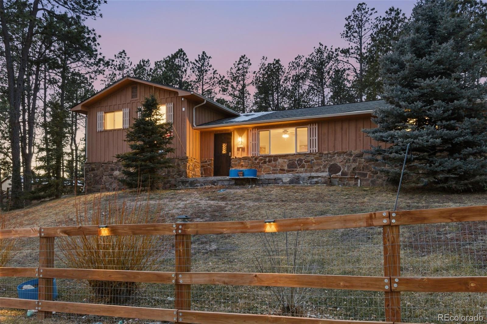 7020 Wildridge Road Colorado Springs, CO 80908 - Photo 5 of 45 a front view of a house with yard