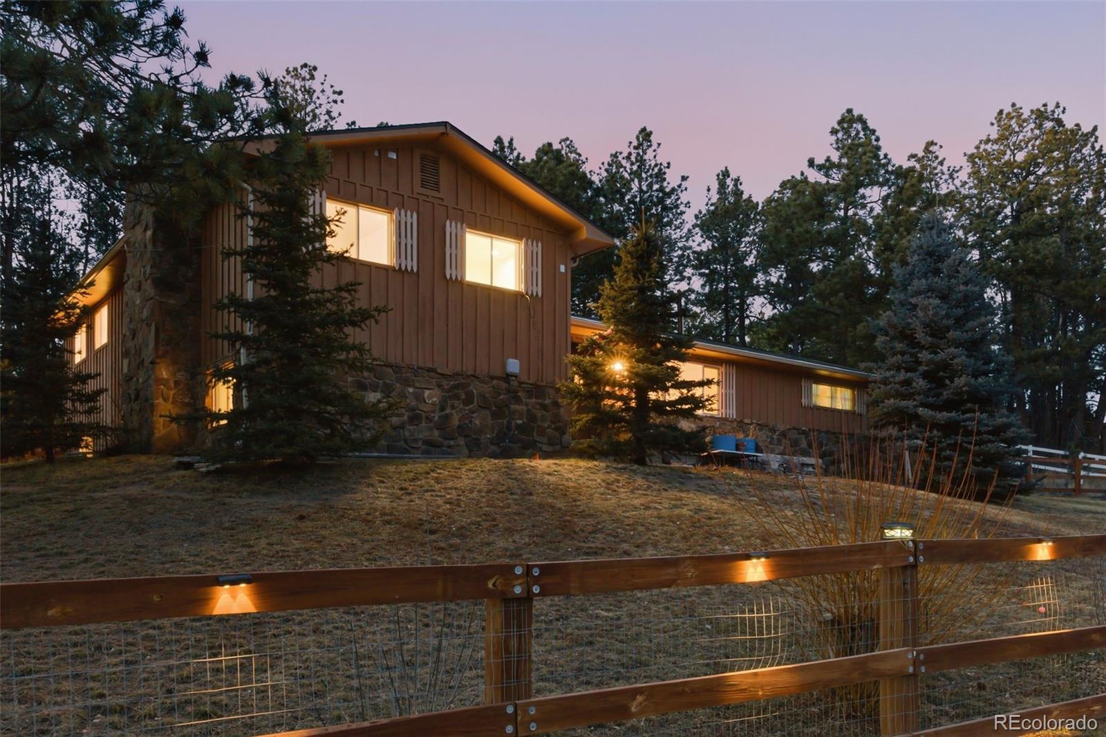 7020 Wildridge Road Colorado Springs, CO 80908 - Photo 8 of 45 a front view of a house with yard