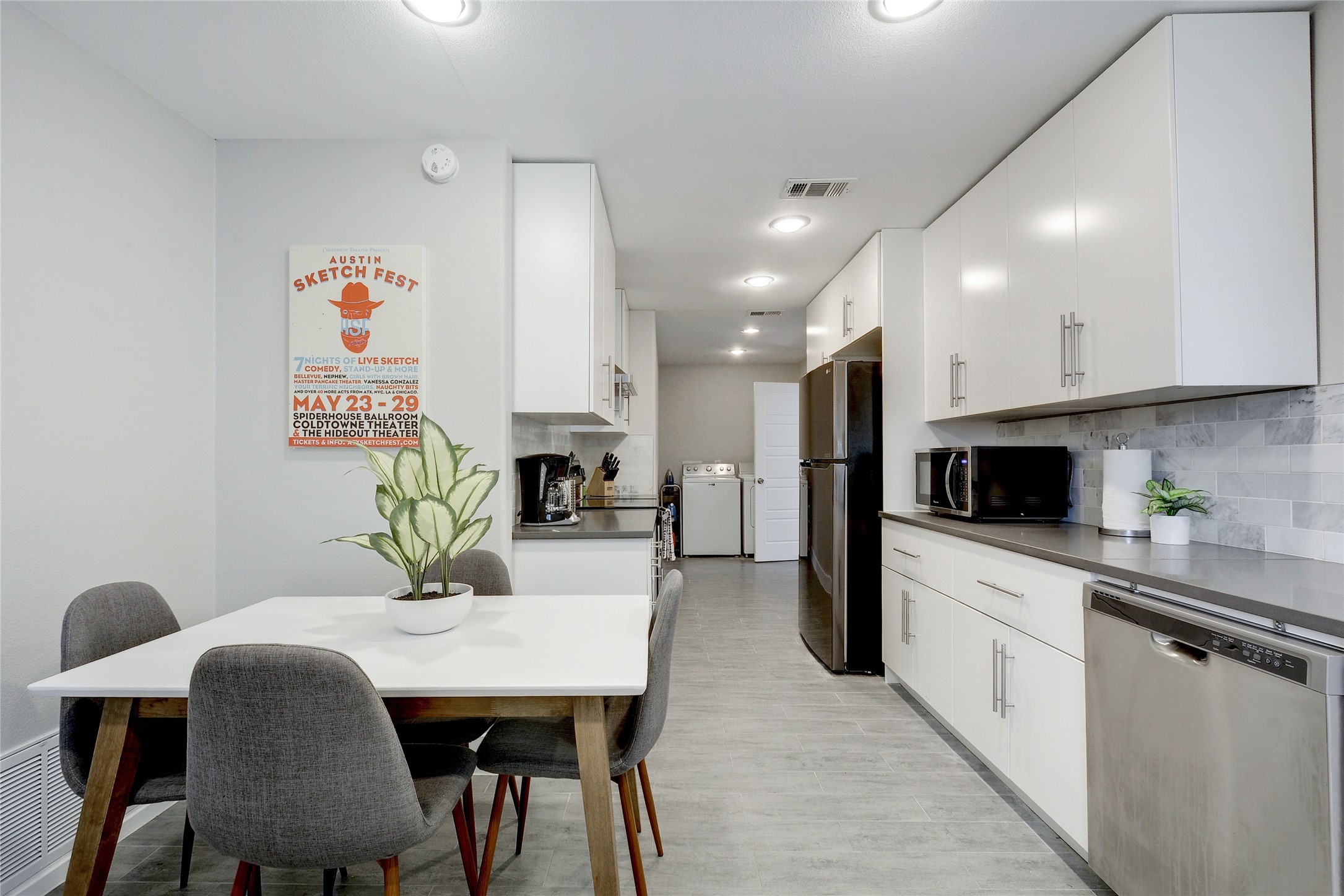 Undisclosed Address Austin, TX 78721 - Photo 9 of 36 Kitchen featuring stainless steel appliances, white cabinets, dark countertops, decorative backsplash, and recessed lighting