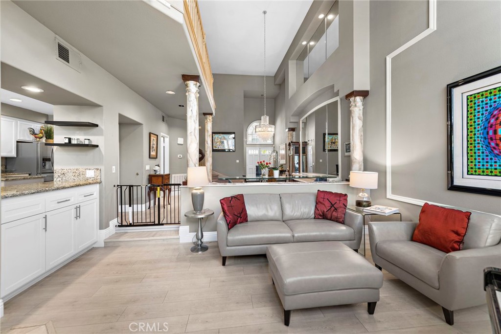 26481 La Scala Laguna Hills, CA 92653 - Photo 11 of 33 a living room with furniture and a kitchen