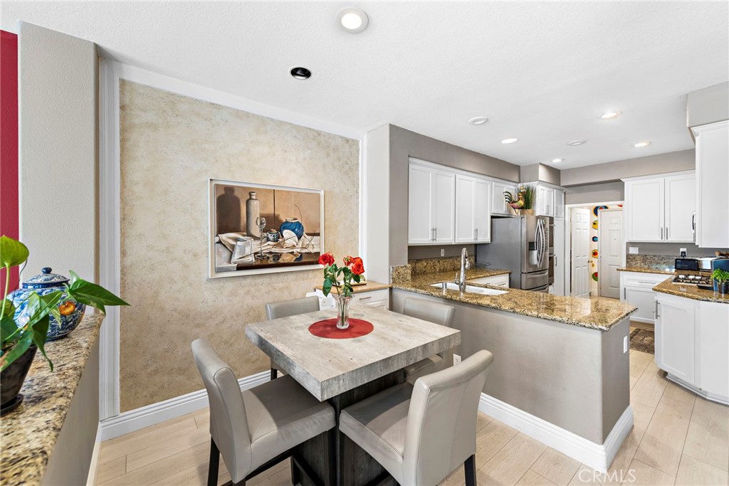 26481 La Scala Laguna Hills, CA 92653 - Photo 15 of 33 a kitchen with a table and chairs in it