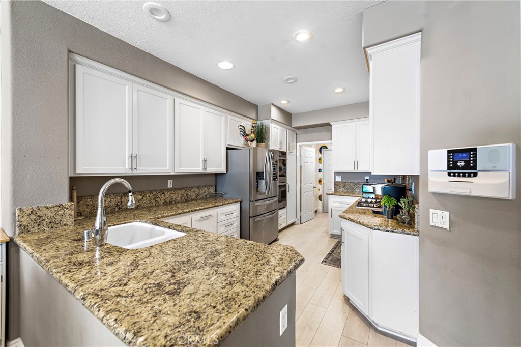 26481 La Scala Laguna Hills, CA 92653 - Photo 17 of 33 a kitchen with a sink stove and refrigerator