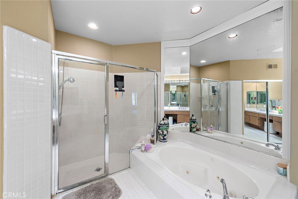 26481 La Scala Laguna Hills, CA 92653 - Photo 28 of 33 a bathroom with a tub shower and sink