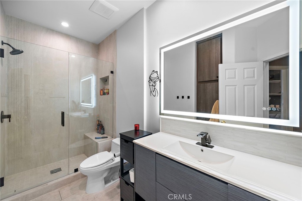 26481 La Scala Laguna Hills, CA 92653 - Photo 32 of 33 a bathroom with a sink toilet a shower and a mirror