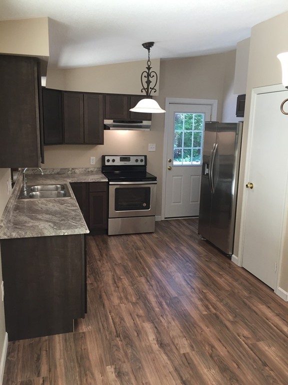 15 Barre Road Templeton, MA 01468 - Photo 4 of 14 a kitchen with stainless steel appliances granite countertop a refrigerator a stove and a wooden floors
