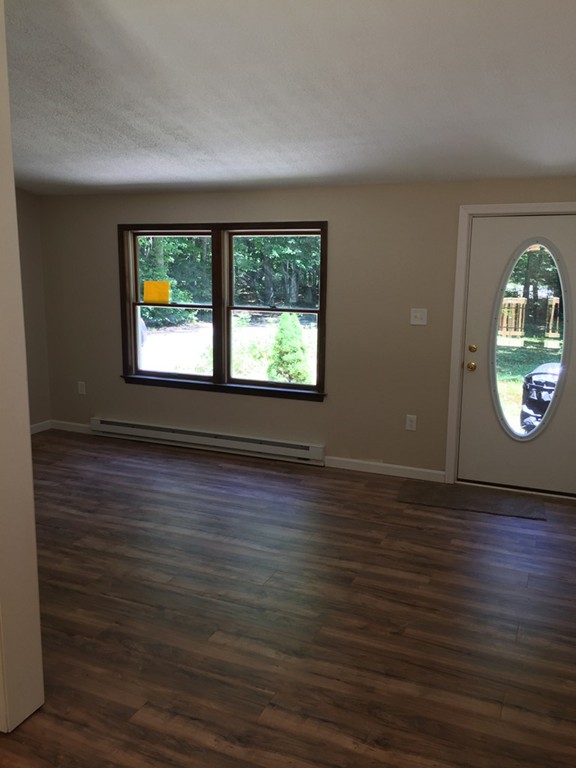 15 Barre Road Templeton, MA 01468 - Photo 6 of 14 an empty room with wooden floor and windows