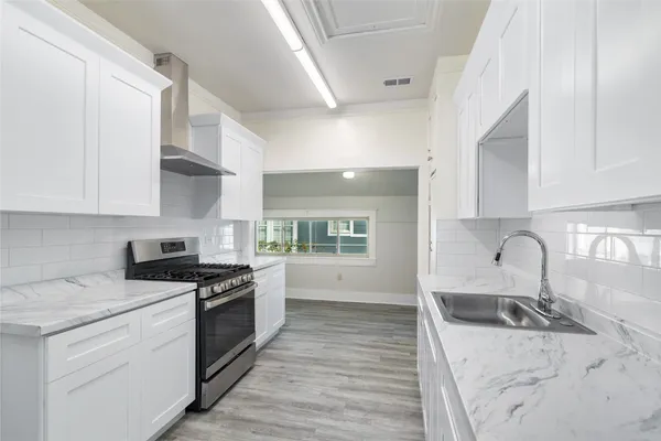 a kitchen with stainless steel appliances granite countertop a stove and a sink