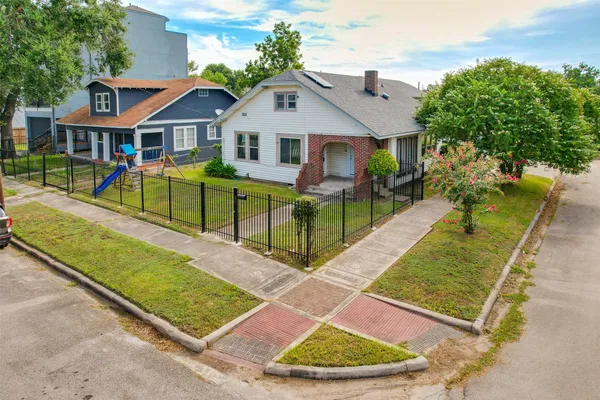 an aerial view of a house with swimming pool and porch