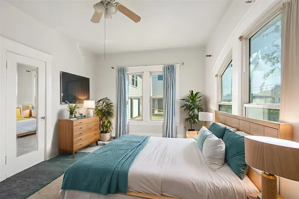 a bedroom with a large bed and a window