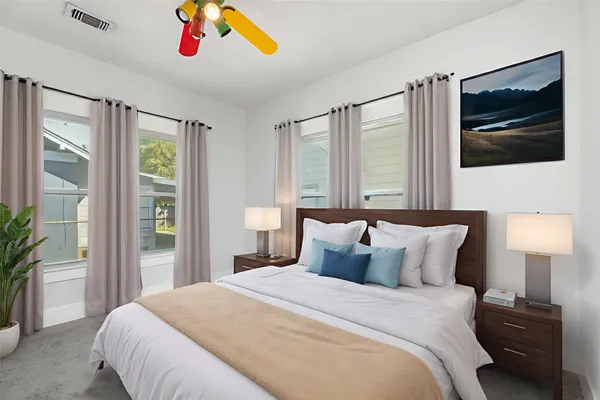 a bedroom with a bed and a flat screen tv