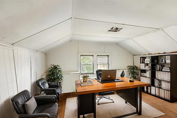 a living room with furniture and book shelf
