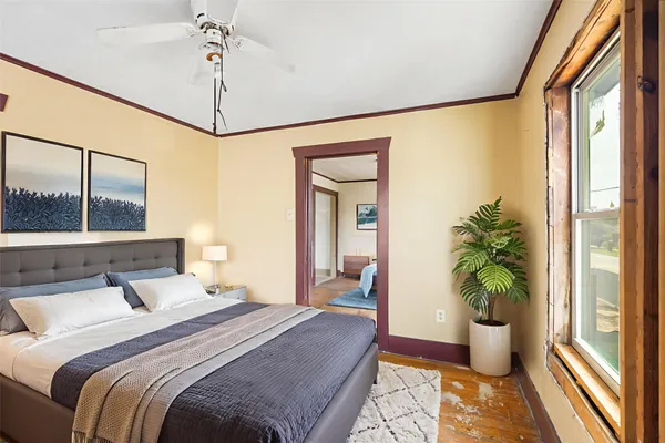 a bedroom with a bed and a potted plant