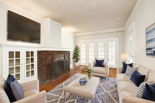 a living room with furniture a flat screen tv and a fireplace