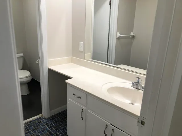 a white toilet sitting next to a sink