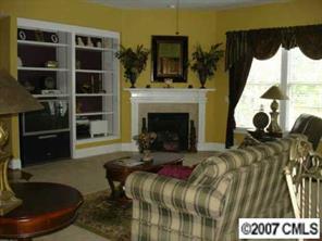 1878 2nd Baxter Crossing Fort Mill, SC 29708 - Photo 7 of 8 a living room with furniture and a fireplace