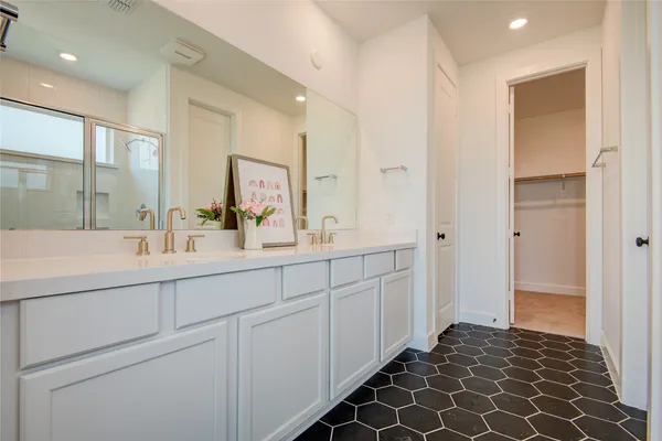a spacious bathroom with a double vanity sink mirror and