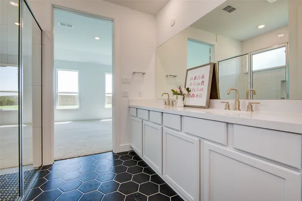 a bathroom with a double vanity sink and a mirror