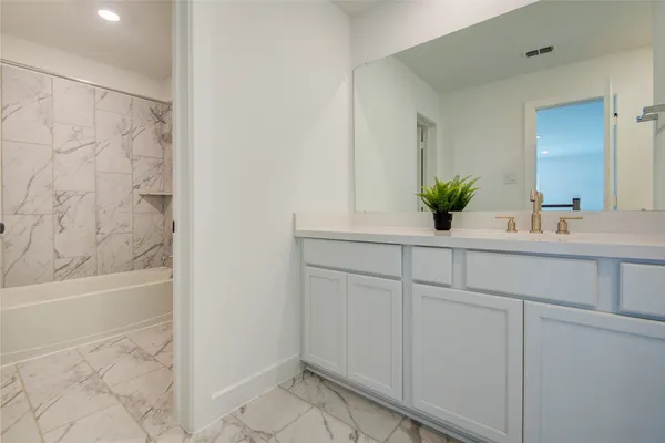 a bathroom with a sink and a bathtub