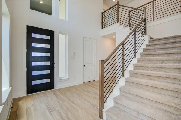 a view of entryway and hall with wooden floor