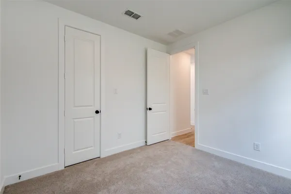 a view of an empty room and closet area